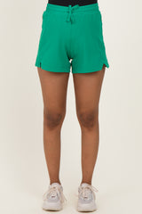 woman wearing green maternity shorts with side slits and drawstring waist