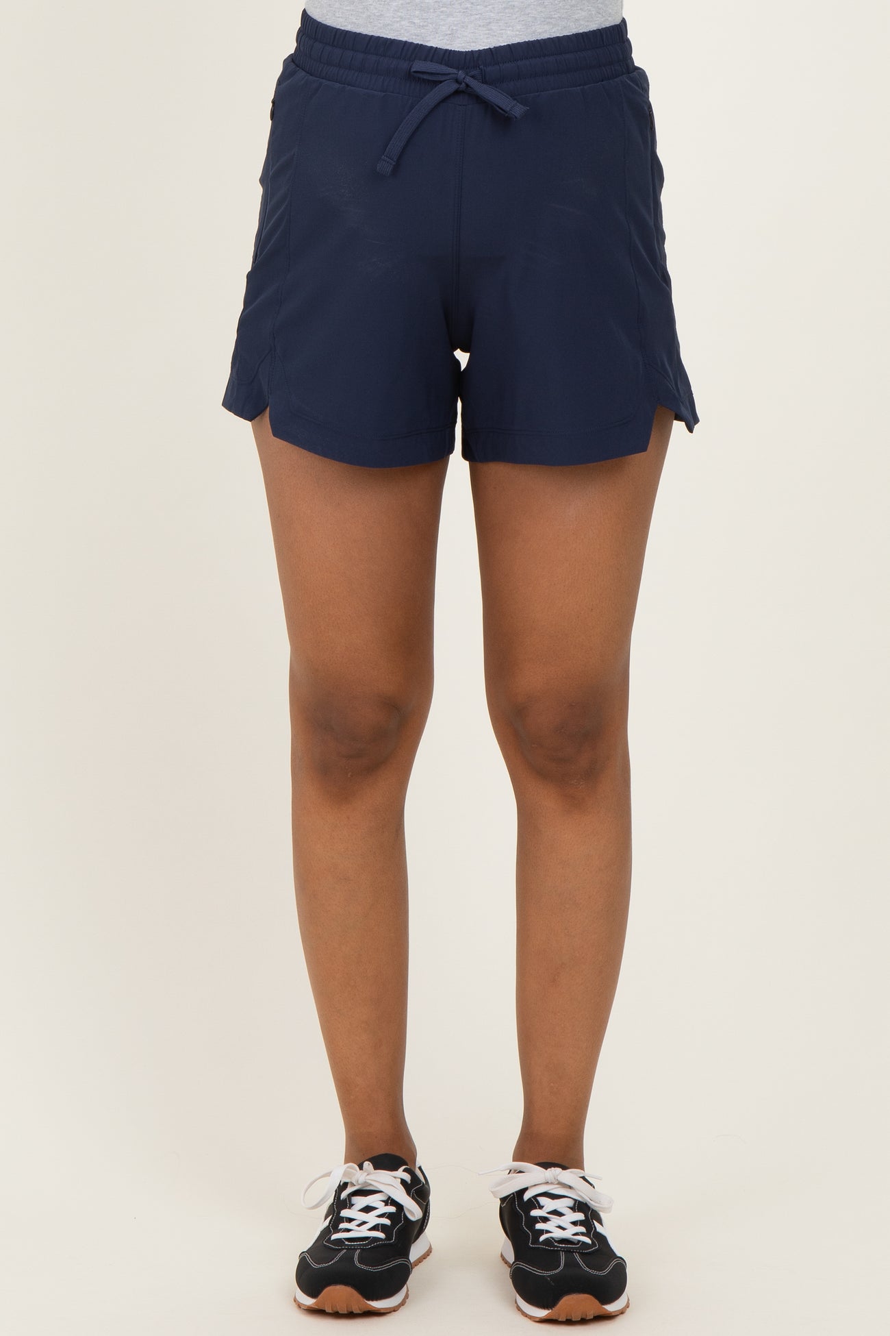 woman wearing navy maternity shorts with an adjustable drawstring waist and side slits