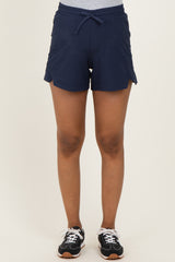woman wearing navy maternity shorts with an adjustable drawstring waist and side slits