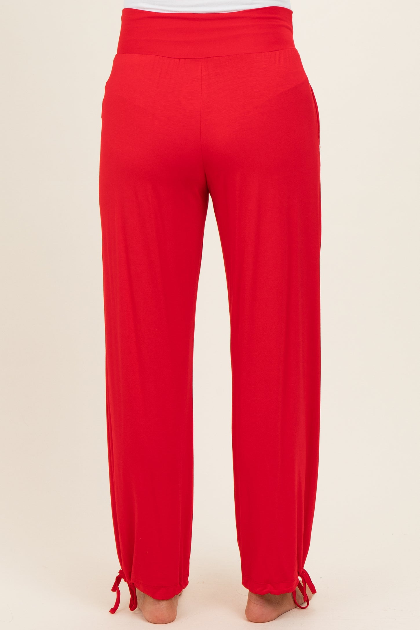 red maternity pants with a comfortable waistband and adjustable ties at the ankles, shown from the back