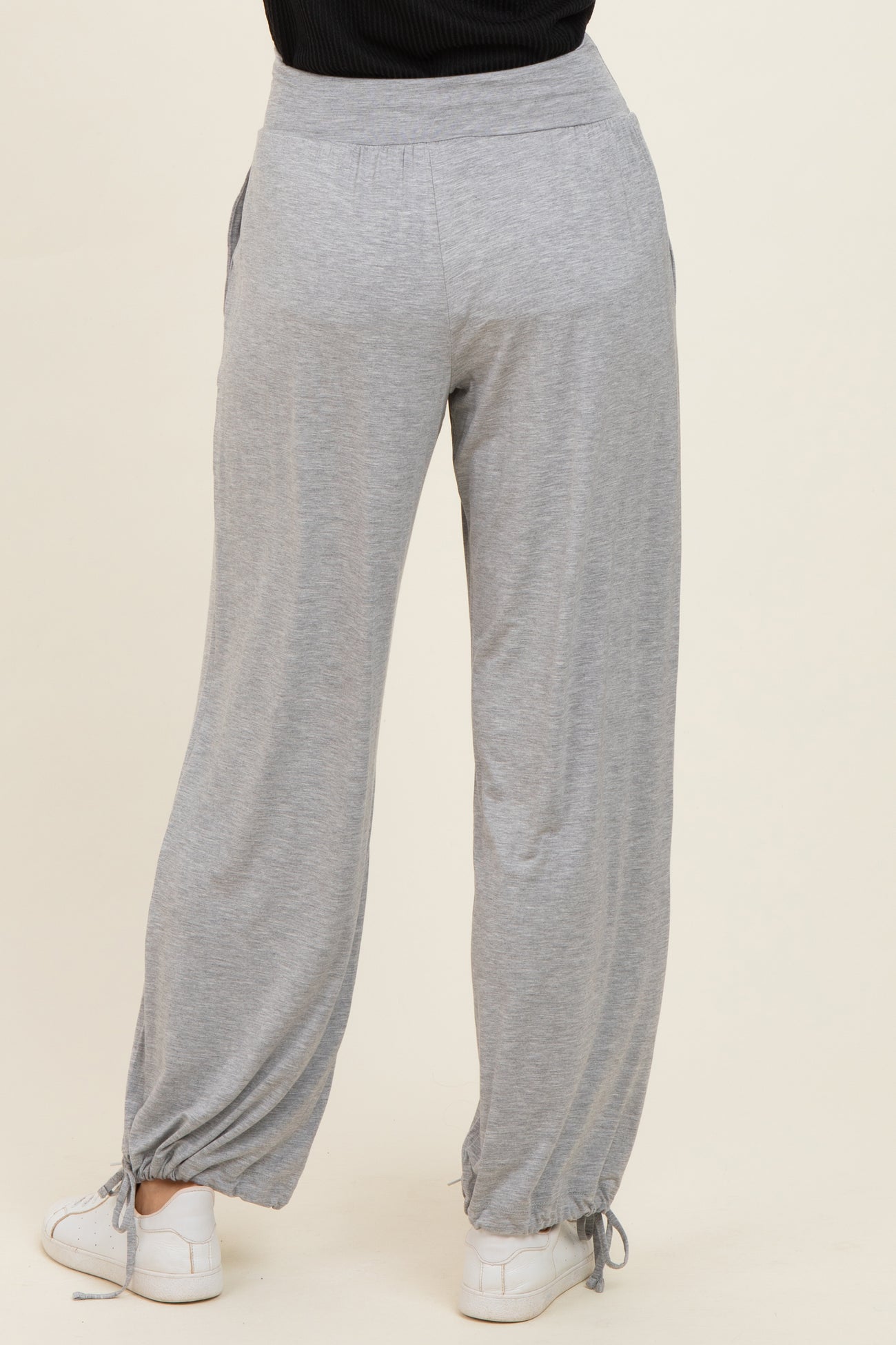 woman wearing gray relaxed fit lounge pants with drawstring and elastic waistband
