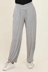 woman wearing light gray wide-leg lounge pants with a ruched hem and a stylish high waistband