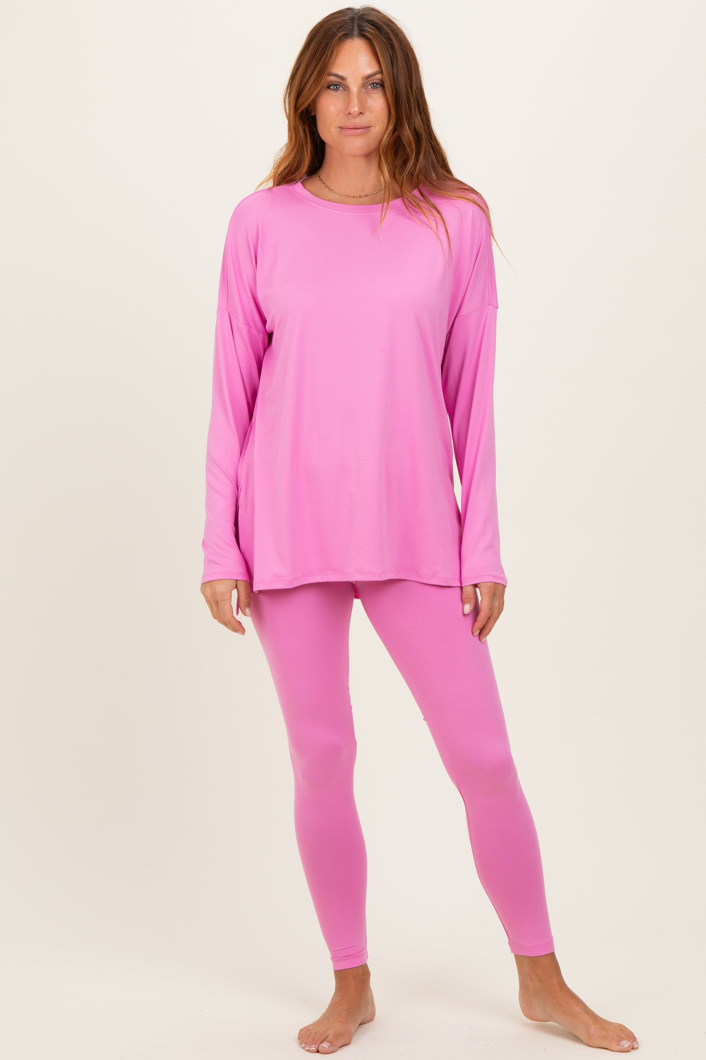 woman wearing a pink long sleeve top and matching leggings