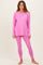 woman wearing a pink long sleeve top and matching leggings