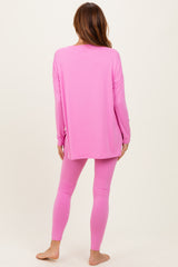 woman wearing a long sleeve pink top and matching pink leggings, viewed from the back