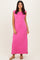 woman wearing a bright pink sleeveless maxi dress standing against a neutral background