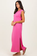 woman wearing a bright pink sleeveless maxi dress with side slits and a relaxed fit