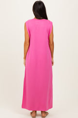 woman wearing a bright pink sleeveless maxi dress, view from the back