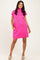 woman wearing a bright pink short sleeve dress with a high neckline and side pockets