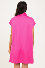 woman wearing a vibrant pink short sleeve dress with a cowl neck from the back