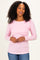 woman wearing a light pink long sleeve ribbed top with a twist front detail and smiling