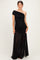 woman wearing a black one-shoulder maternity gown with a fitted bodice and flowy sheer skirt
