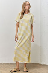 woman wearing a yellow and white striped short sleeve maxi dress with a side slit and a relaxed fit