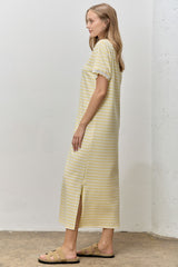 woman wearing a yellow and white striped midi dress with short sleeves and side slit