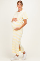woman wearing a yellow and white striped maternity dress with short sleeves and a side slit, showing her baby bump