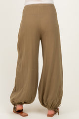 woman wearing olive green maternity palazzo pants with a relaxed fit and gathered hem details