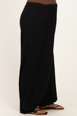 maternity wear black wide-leg pants with a relaxed fit, model wearing with flat sandals and a fitted top
