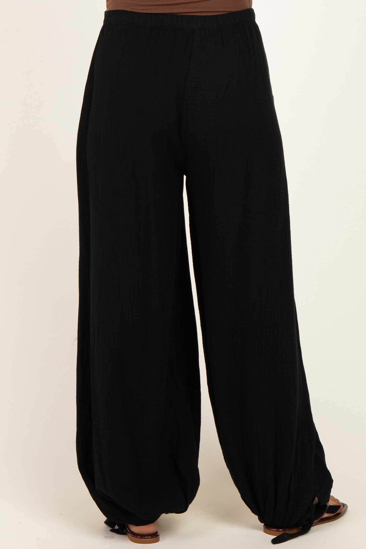 woman wearing black maternity wide-leg pants with a comfortable elastic waistband and relaxed fit