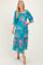 woman wearing a blue floral maxi dress with puff sleeves and tiered skirt