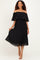 woman wearing a black off-shoulder pleated midi dress with ruffle details and strappy sandals