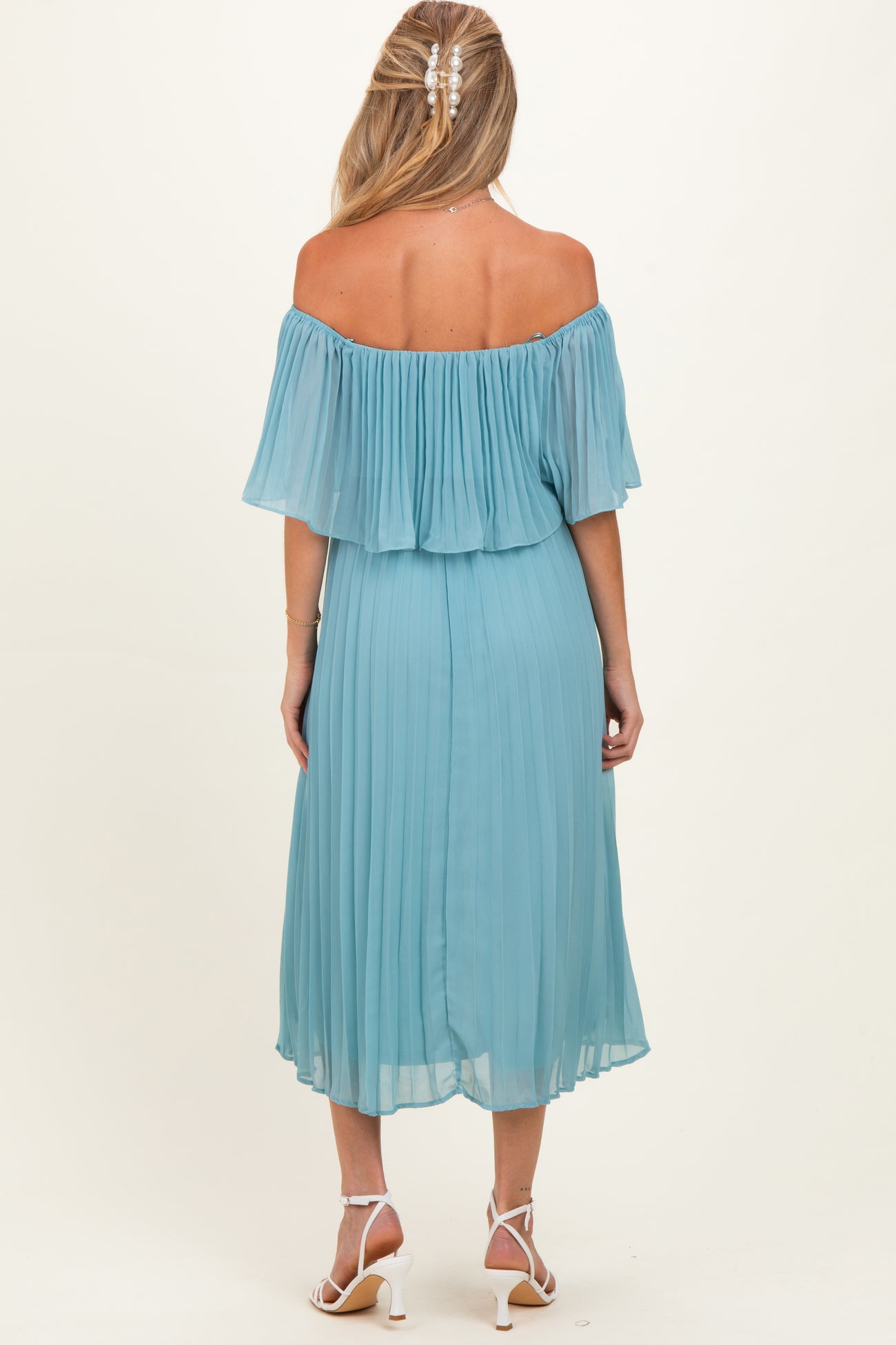 woman wearing a light blue off-the-shoulder pleated maternity dress with a flowy skirt