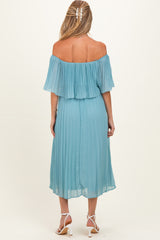 woman wearing a light blue off-the-shoulder pleated maternity dress with a flowy skirt