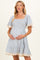 woman wearing a blue and white striped maternity dress with short sleeves and lace trim, holding her baby bump