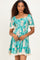 woman wearing a teal floral dress with short puff sleeves and lace trim
