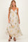woman wearing a floral maternity maxi dress with a plunging neckline and adjustable straps
