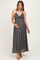 woman wearing a black floral maternity maxi dress and holding her baby bump