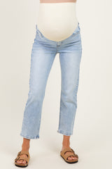 woman wearing light blue maternity jeans with a supportive belly band and a cropped flared leg style