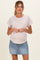 woman wearing a striped maternity top and a denim mini skirt, showing her baby bump