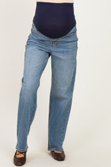 woman wearing maternity light wash straight leg jeans with a navy blue over-the-bump panel