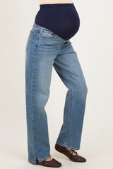 woman wearing a pair of light blue maternity jeans with a supportive belly band and a visible baby bump