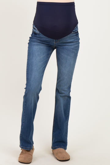 maternity wear medium wash bootcut jeans with a navy blue over the belly panel, model not wearing the pants
