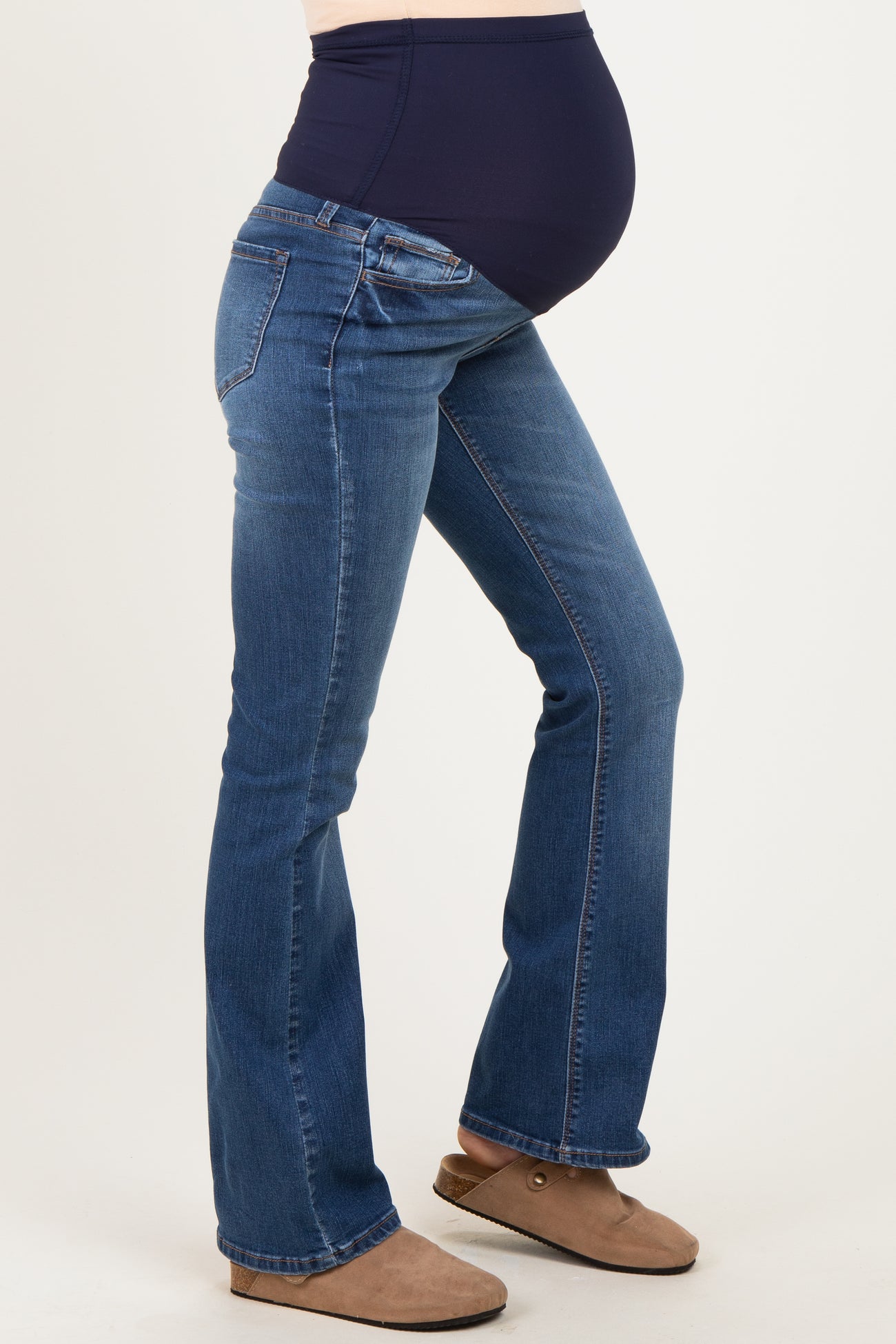 woman wearing dark blue maternity jeans with a stretchy waistband and visible baby bump