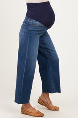 woman wearing dark blue maternity wide-leg jeans with a stretchy waistband and visible baby bump
