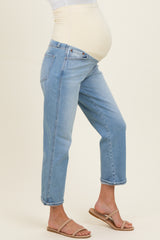 woman wearing light blue maternity jeans with a stretchy beige panel and a visible baby bump