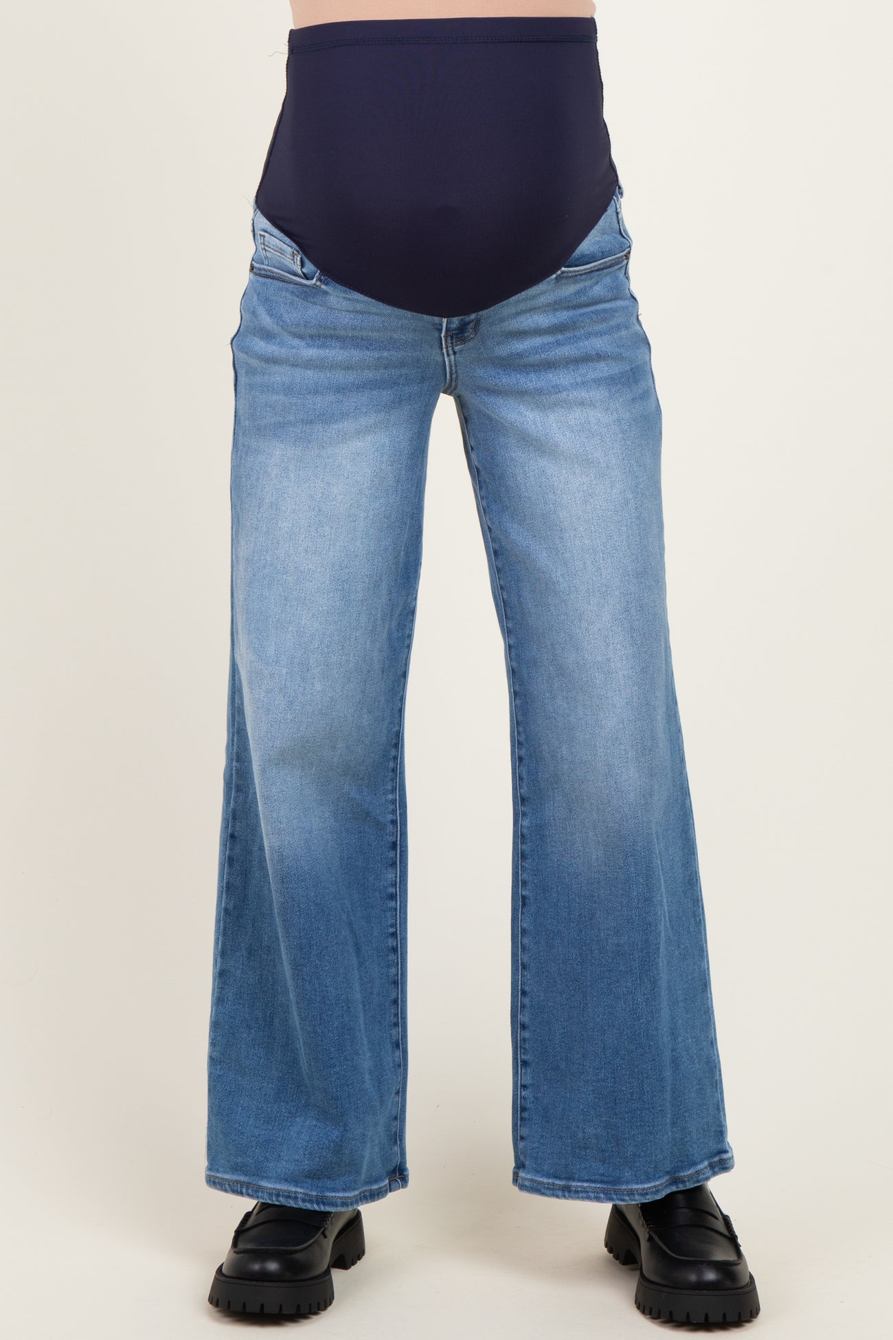 woman wearing blue maternity wide-leg jeans with a dark blue over-the-bump waistband