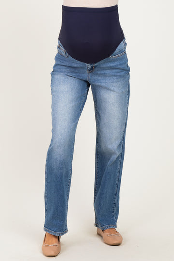 woman wearing a pair of light blue maternity jeans with a navy over-the-bump panel and a straight leg cut