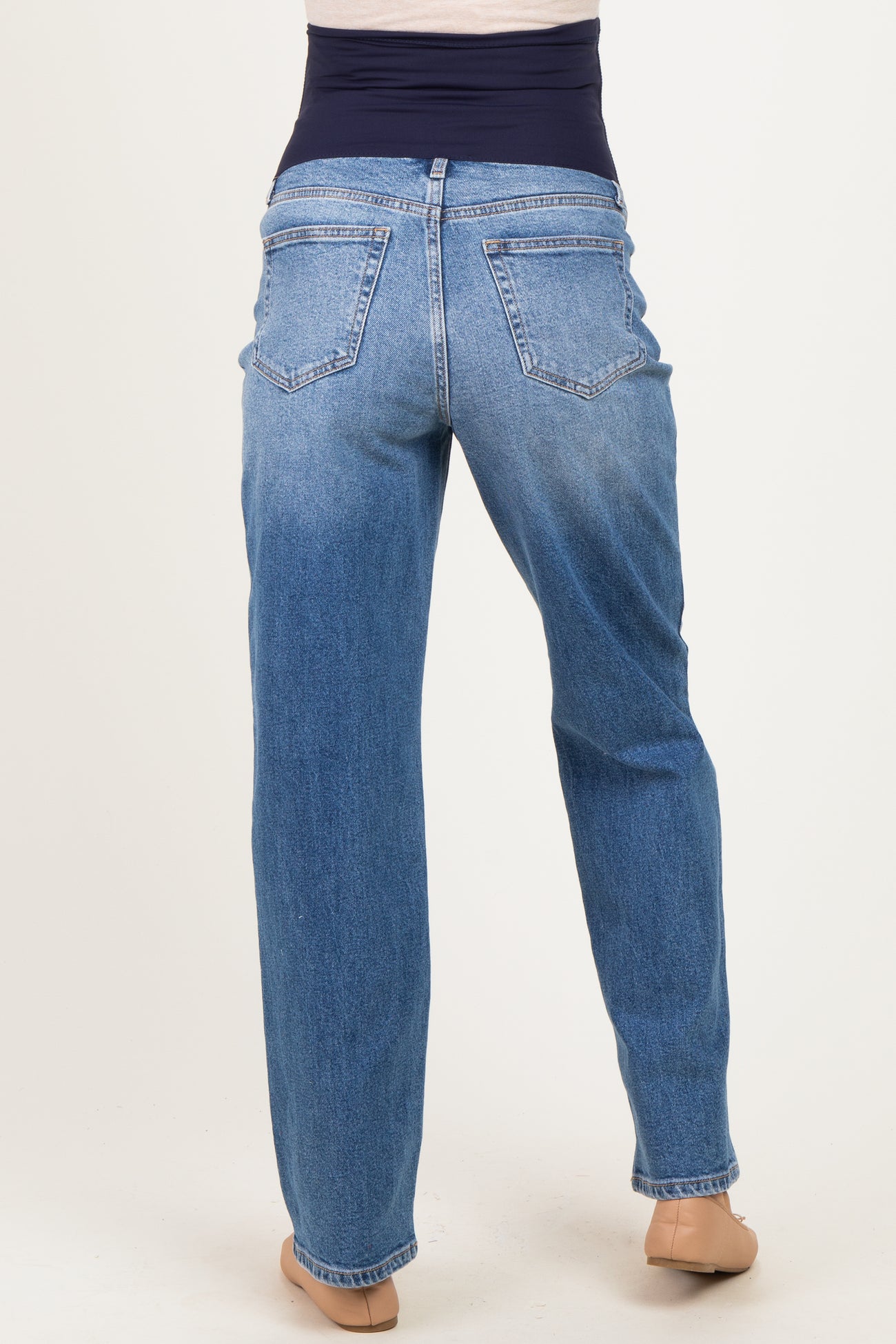 maternity wear light blue denim straight leg jeans with a stretchy navy waistband and no visible baby bump