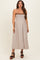 woman wearing a brown and white gingham maternity dress with smocked bodice and adjustable spaghetti straps