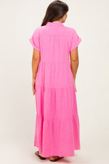 woman wearing a pink tiered maxi maternity dress, showing the back view with short sleeves