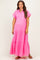 woman wearing a bright pink maternity maxi dress with short sleeves and button-down front