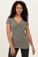 woman wearing a short sleeve olive green ribbed top with a v-neck and fitted silhouette