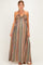 woman wearing a multicolored striped maternity maxi dress with a halter neck and flowing silhouette, showcasing her baby bump