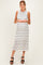 woman wearing a striped sleeveless maternity dress that highlights her baby bump