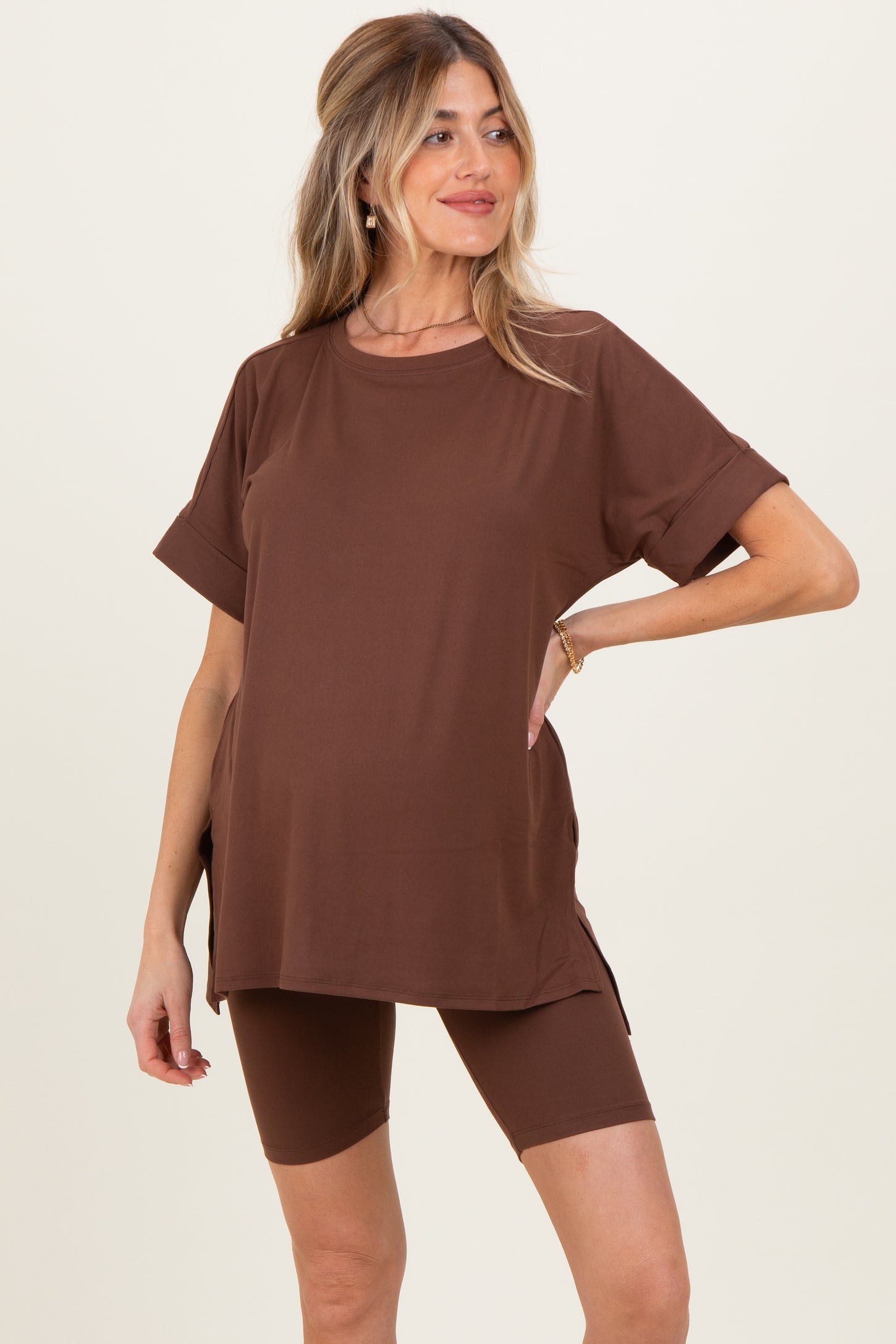 woman wearing a brown maternity oversized t-shirt and matching bike shorts with side slits