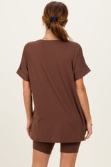 woman wearing a oversized brown t-shirt and matching shorts, viewed from the back