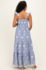woman wearing a blue and white striped maternity maxi dress with ruffle straps and floral print from the back